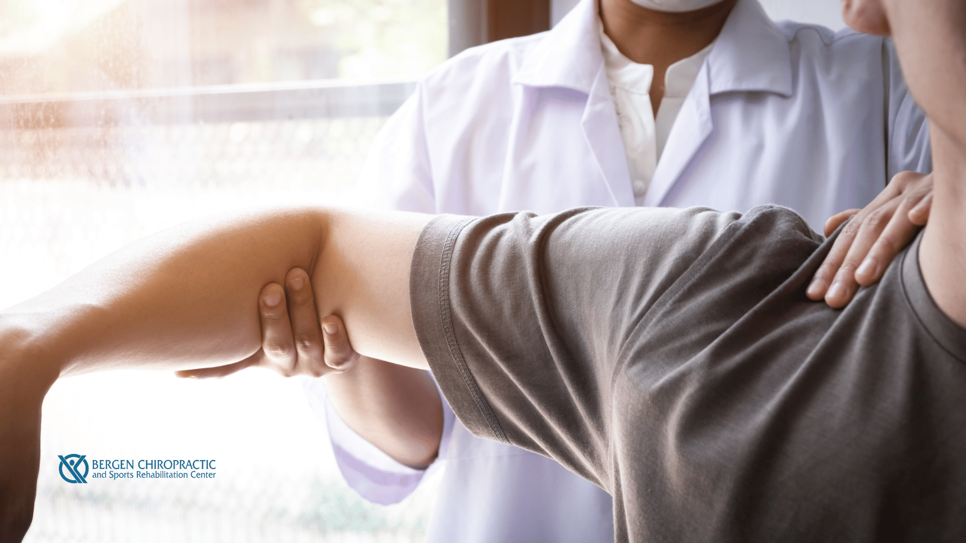 Chiropractor adjusting patient's shoulder