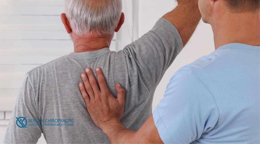 Chiropractic adjustment on male patient with back pain