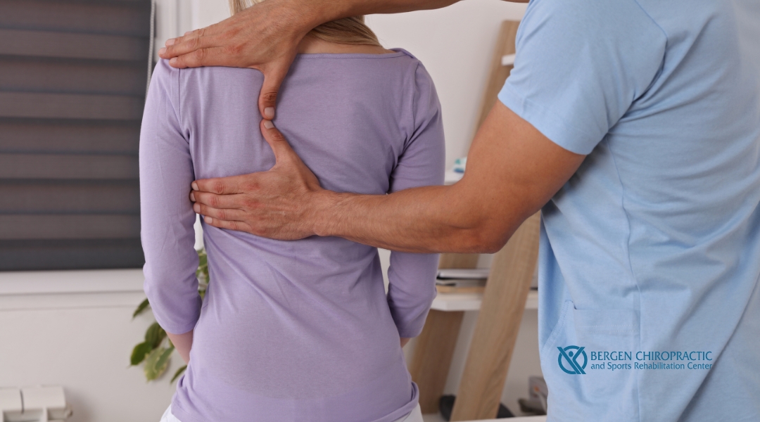 A chiropractor performing an upper back adjustment on a patient, focusing on relieving tension and improving mobility.