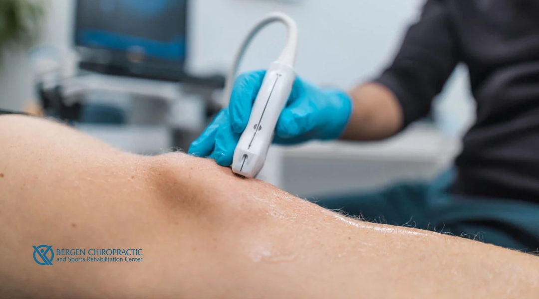 Healthcare provider using a therapeutic ultrasound device on a patient’s knee to reduce inflammation and support IT band recovery.